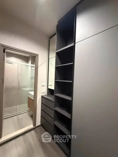 Modern bathroom with sleek storage and glass shower enclosure