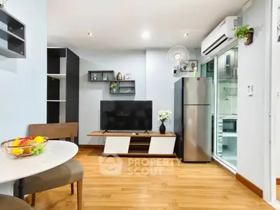 Modern living room with sleek TV unit and stainless steel fridge, open layout design, and stylish decor.