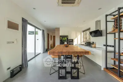 Modern kitchen with sleek design, featuring a large wooden island and open layout, perfect for entertaining.