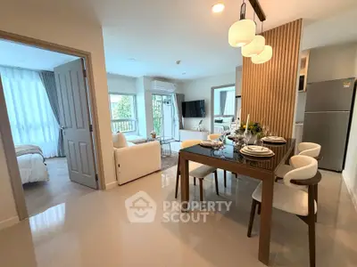 Modern open-plan living and dining area with stylish decor and natural light.
