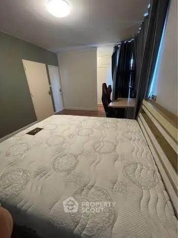 Spacious bedroom with modern decor and ample natural light