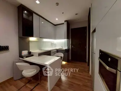 Modern kitchen with sleek cabinetry and built-in appliances in a stylish apartment.