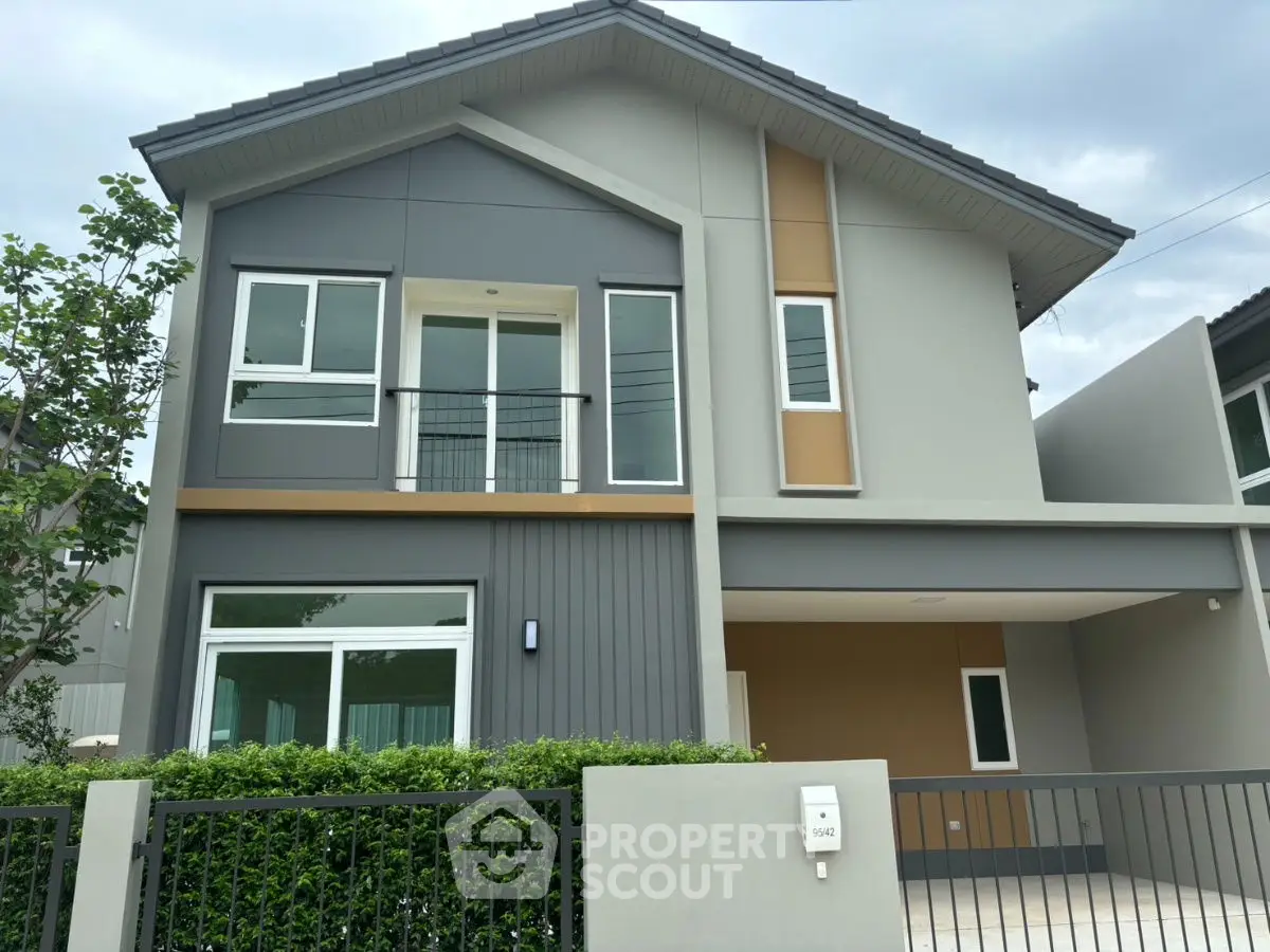 Modern two-story house with sleek design and spacious balcony in a serene neighborhood.