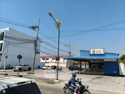 Modern laundromat exterior with ample parking in urban setting