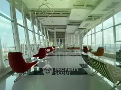 Luxurious modern building interior with panoramic city views and stylish seating area.