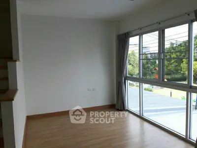 Bright corner unit with large windows and serene view, perfect for modern living.