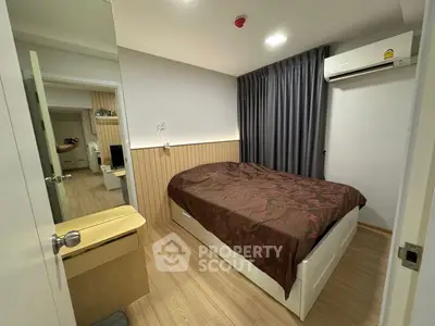 Cozy bedroom with modern decor and air conditioning in a stylish apartment.