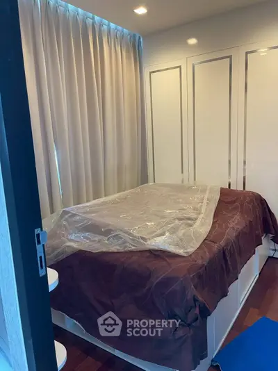 Cozy bedroom with elegant curtains and built-in wardrobe, perfect for a restful retreat.