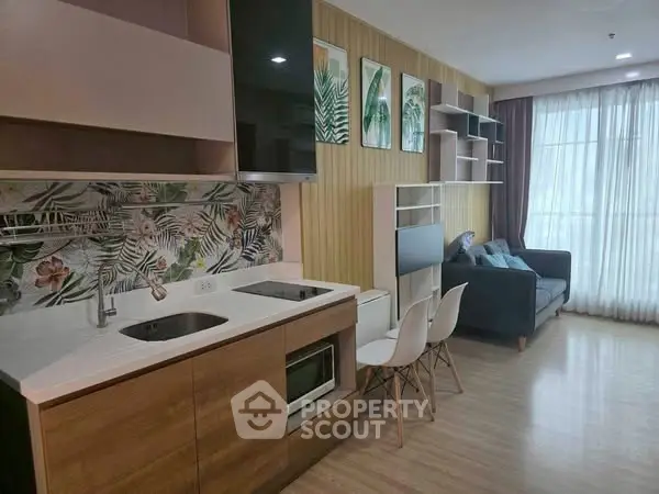 Modern open-layout kitchen and living room with stylish decor and natural light