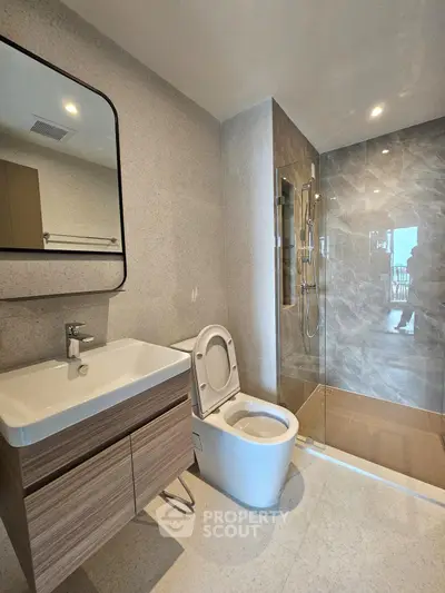 Modern bathroom with sleek fixtures and spacious shower area