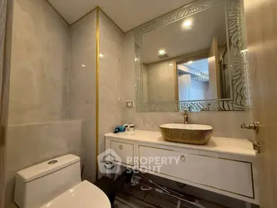 Luxurious bathroom with elegant vanity and modern fixtures in a stylish real estate property.
