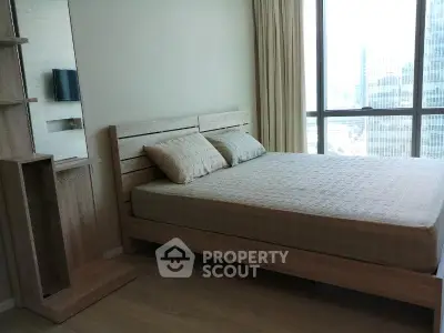 Modern bedroom with large window and wooden furniture in high-rise apartment