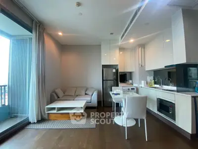 Modern open-layout living room with kitchen and balcony view