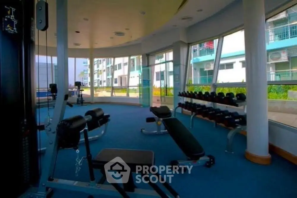 Modern gym with panoramic windows in upscale residential building