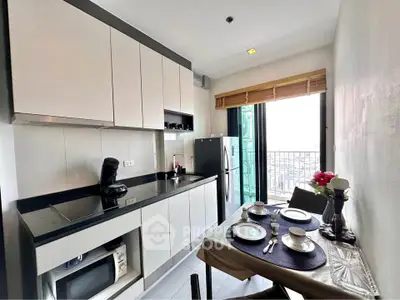 Modern kitchen with sleek cabinets and balcony view