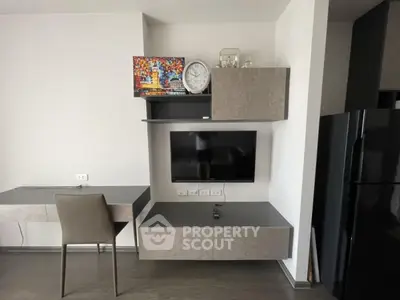 Modern living room with wall-mounted TV and sleek furniture design