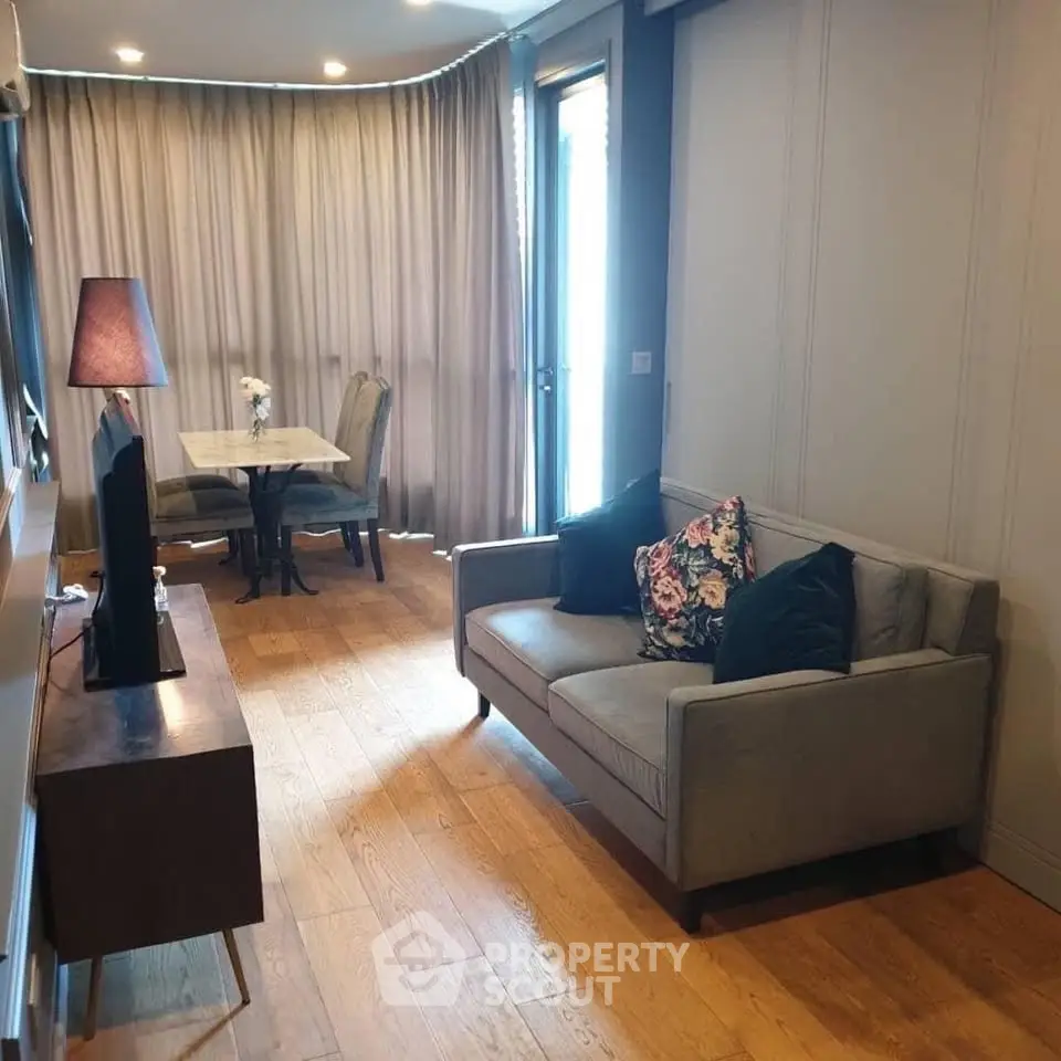 Chic modern living room with cozy sofa, stylish lamp, and elegant dining area, perfect for urban living.