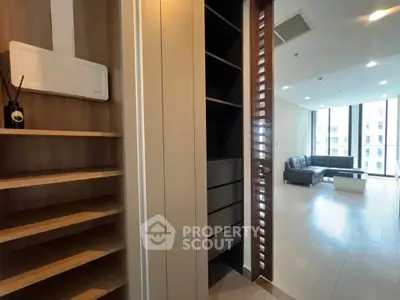 Spacious modern living room with sleek shelving and ample natural light