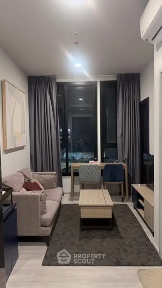 Modern living room with stylish furniture and large window view
