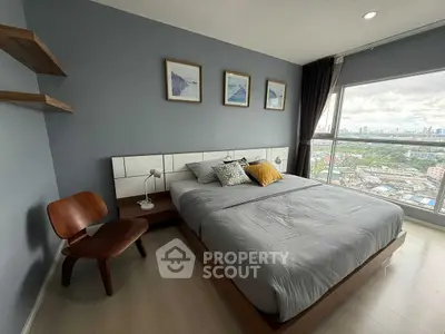 Modern bedroom with city view, stylish decor, and large window for natural light.