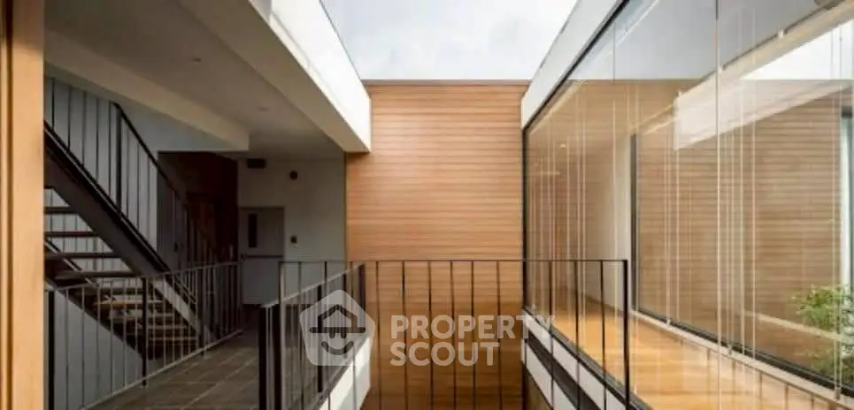 Modern architectural design with open corridors and glass walls in a contemporary building.