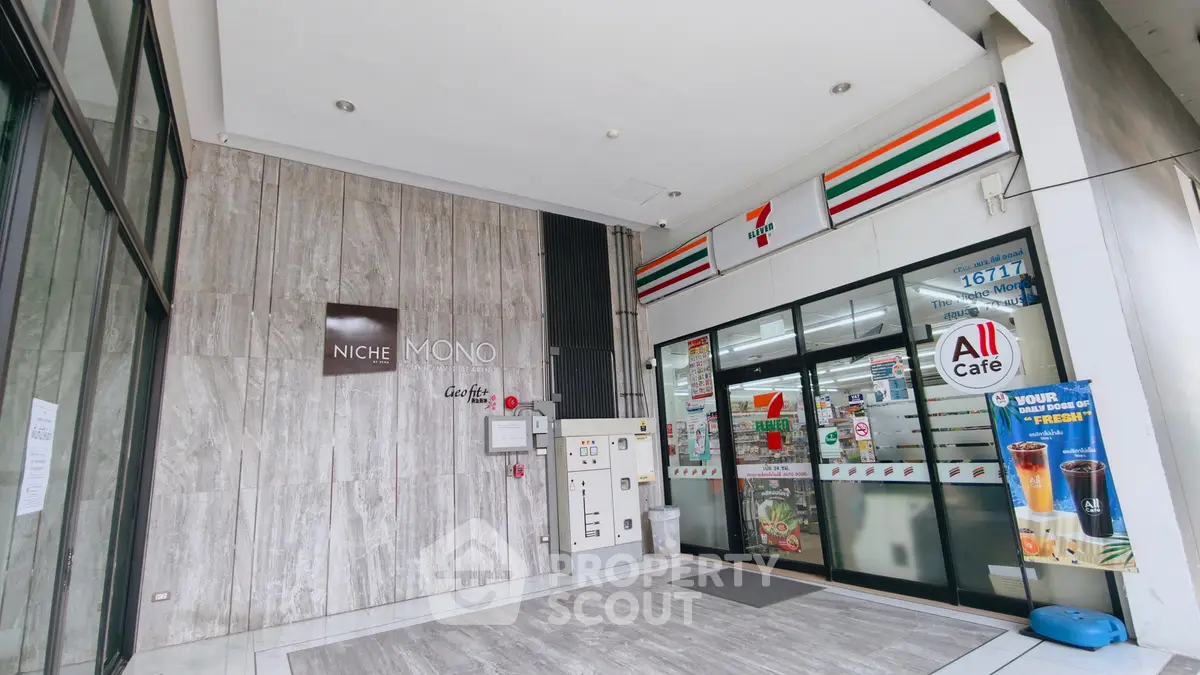 Modern commercial building entrance with convenience store and sleek design.