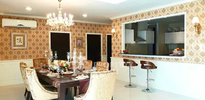 Luxurious dining room with elegant chandelier and open kitchen layout