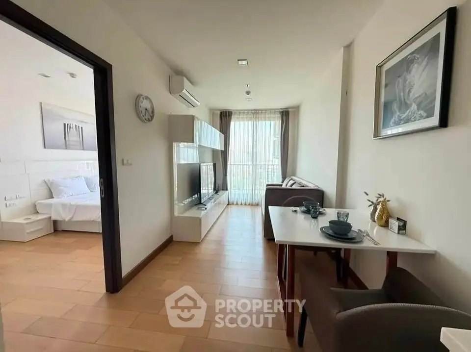 Modern apartment interior with open living and dining area, featuring stylish decor and natural light.