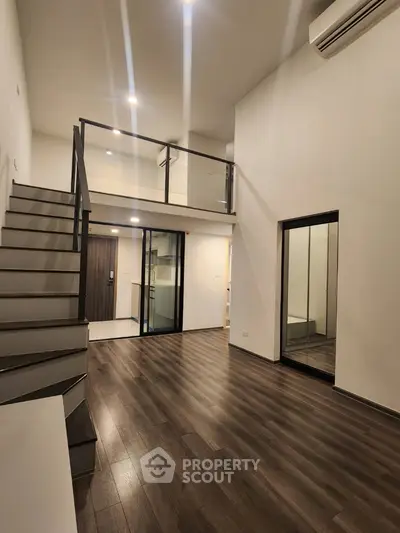 Modern duplex apartment with sleek staircase and wooden flooring