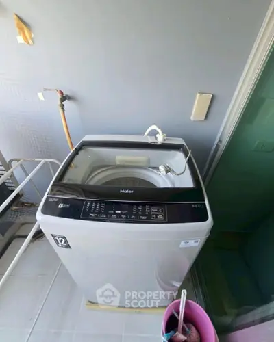 Modern washing machine on a balcony with a sleek design, perfect for urban living spaces.