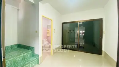 Spacious interior with sliding glass doors and adjacent bathroom, ideal for modern living.
