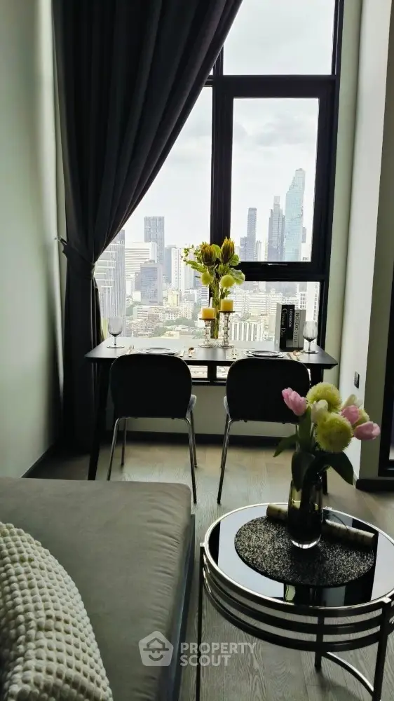 Modern apartment with stunning city view, elegant dining setup, and cozy living area.