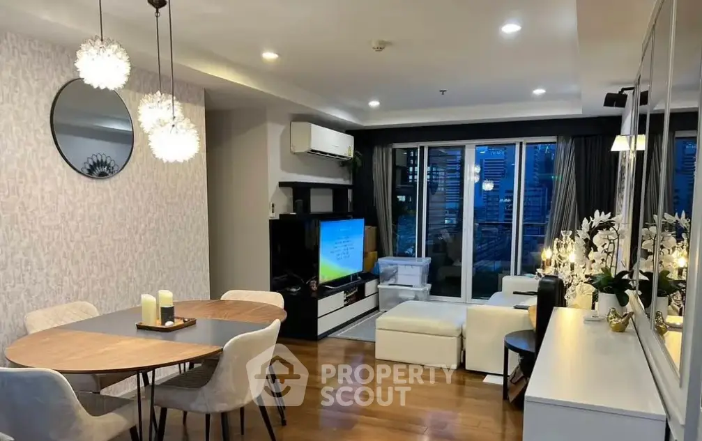 Modern living room with elegant decor and city view, featuring stylish furniture and ambient lighting.