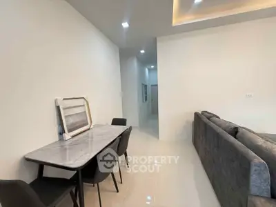 Modern living room with sleek dining area and stylish furniture