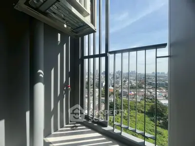 Stunning city view from a high-rise balcony with modern railing design.