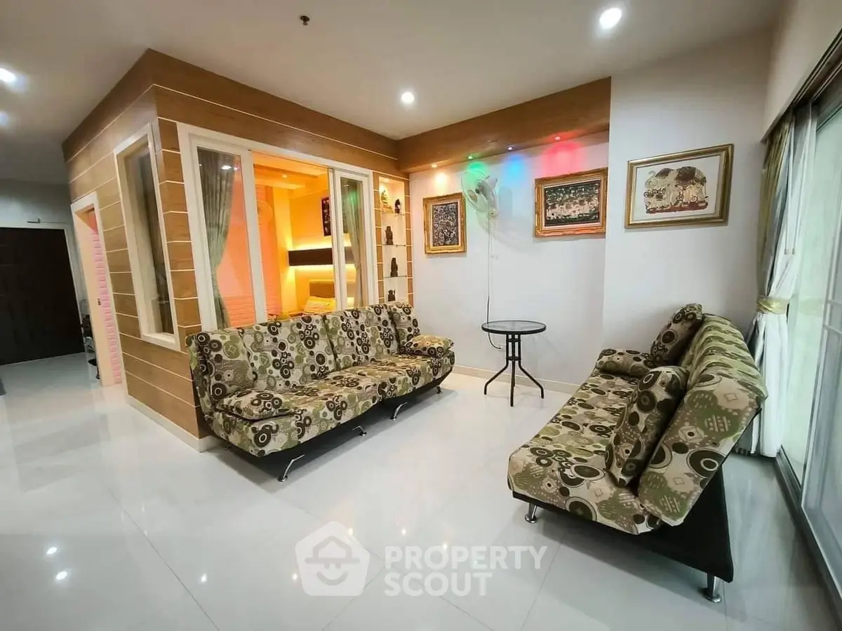 Spacious living room with modern decor and stylish furniture in a cozy apartment.