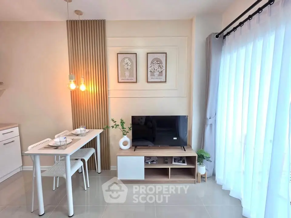 Modern living room with stylish decor, dining area, and natural light from large windows.