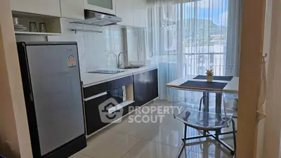 Modern kitchen with sleek design and mountain view from window.