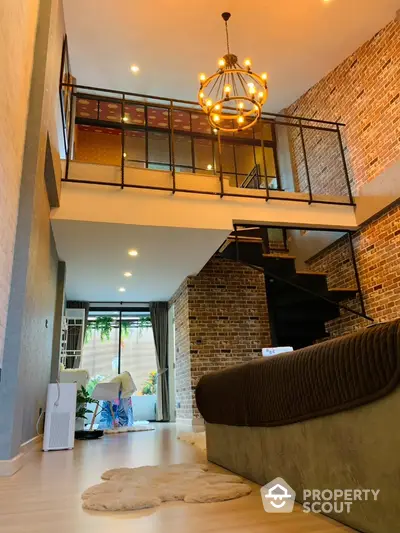 Stunning loft apartment with modern chandelier and exposed brick walls