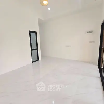 Spacious modern room with sleek white flooring and minimalist design, perfect for customization.