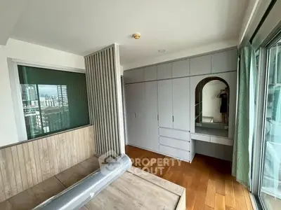 Modern bedroom with built-in wardrobe and city view