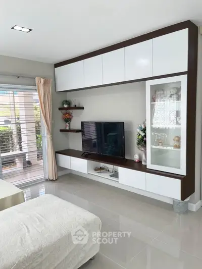 Modern living room with sleek cabinetry and large window for natural light