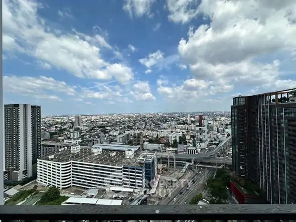 Stunning cityscape view from high-rise balcony with clear blue sky