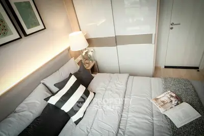 Cozy bedroom with modern design, featuring a large bed with stylish bedding, sleek built-in wardrobe, and warm ambient lighting.
