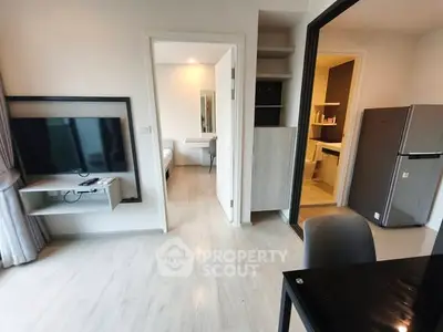 Modern apartment interior with open layout, featuring a sleek kitchen and cozy living area.