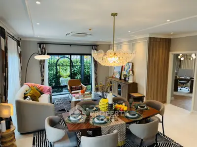 Luxurious open-plan living and dining area with elegant decor and garden view.
