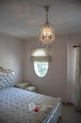 Elegant bedroom with luxurious chandelier and stylish decor