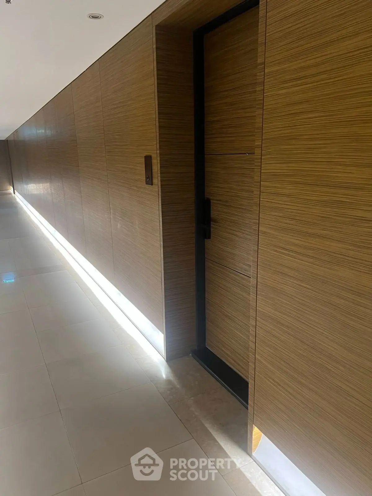 Sleek modern hallway with wooden paneling and ambient lighting