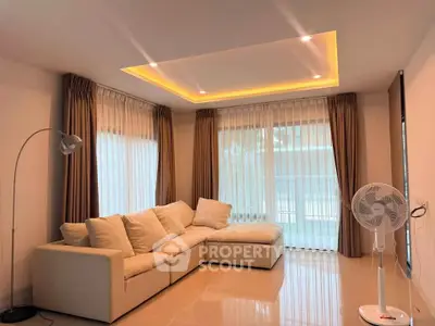 Spacious living room with modern lighting and cozy sectional sofa