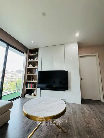 Modern living room with sleek TV setup and balcony view